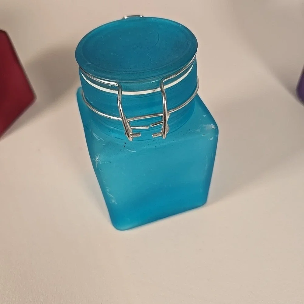 Set Of Four Colored‎ Glass Cannisters With Locking Tops Very Good Condition